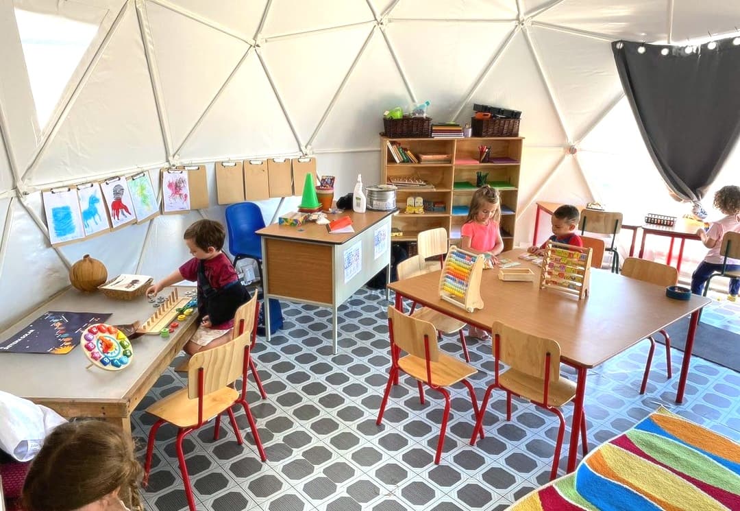 Children learning in geodesic dome classroom