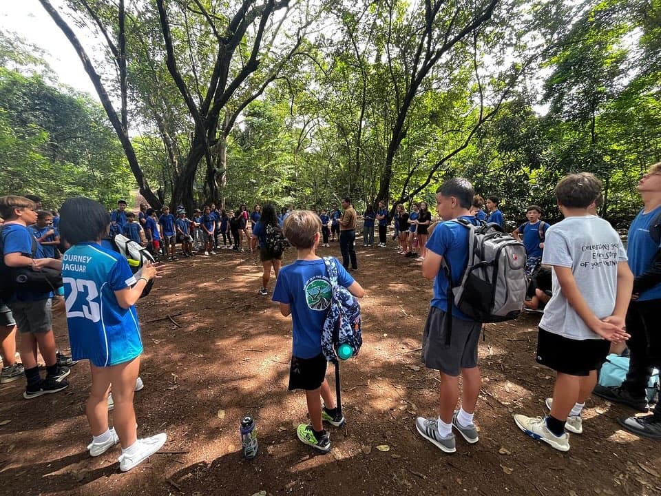 Journey students walking into the forest on a field trip